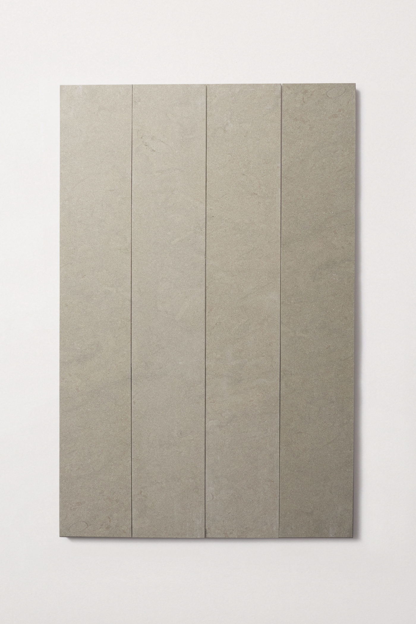 four long grey rectangle tiles on a white surface.