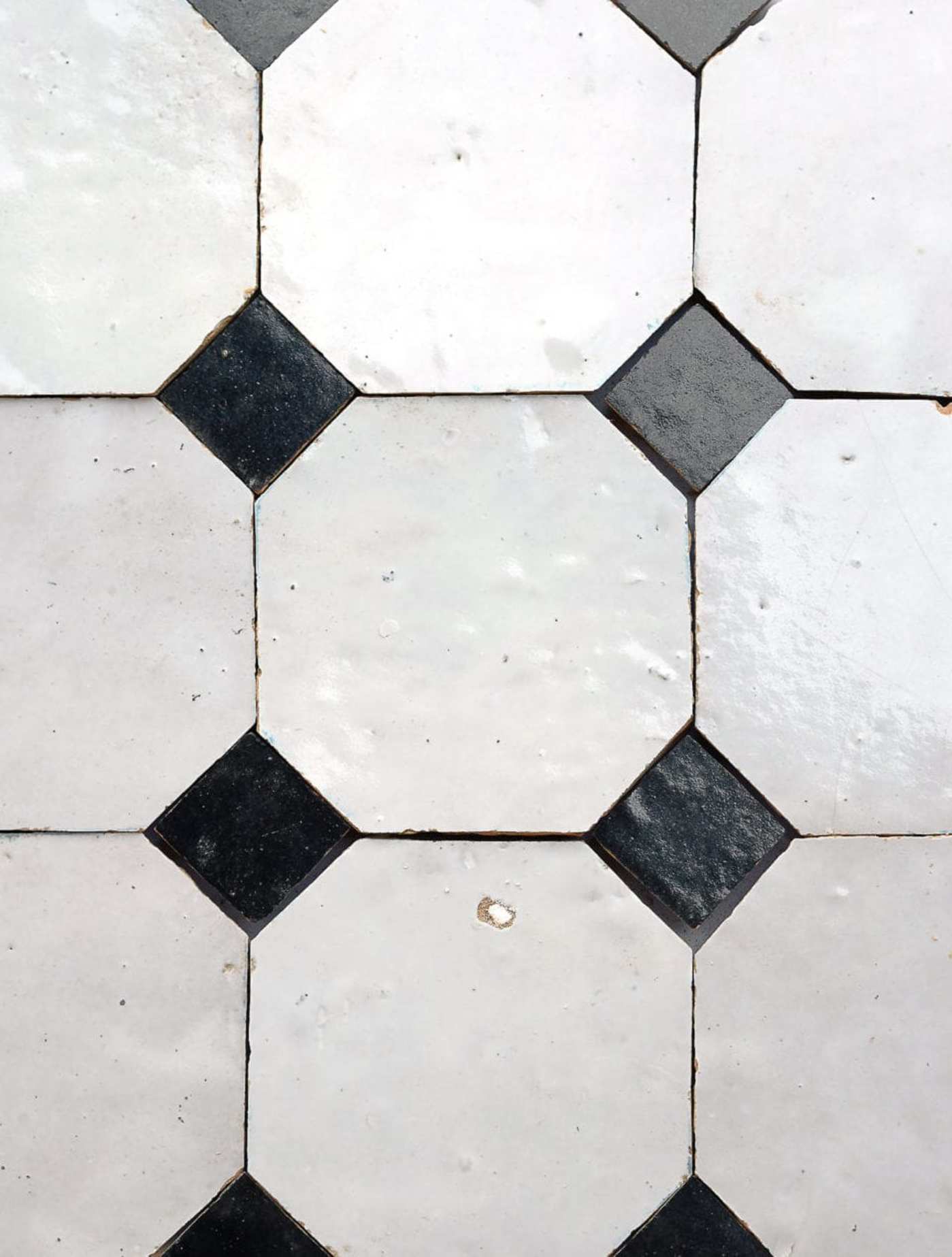 black and white tiles arranged in a pattern.