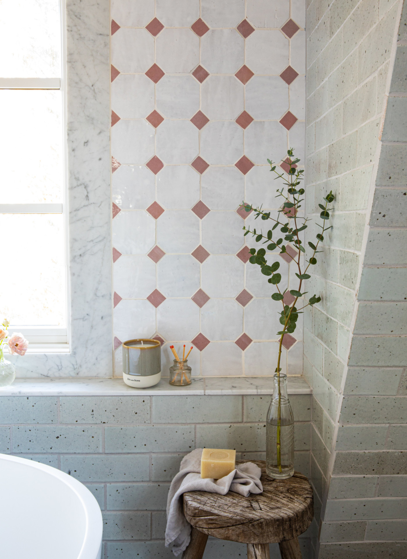 a bathroom with a tub and a window.