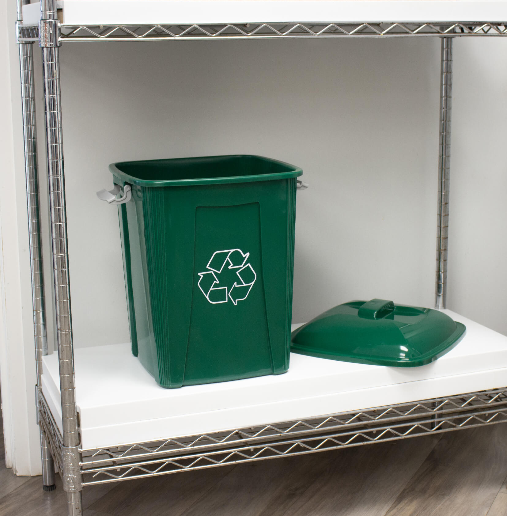 green plastic recycling container with a lockable lid on a shelf in a corporate office lunch room