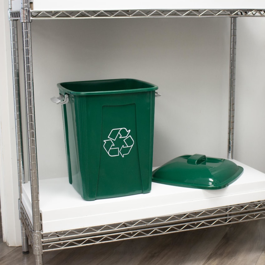 green plastic recycling container with a lockable lid on a shelf in a corporate office lunch room