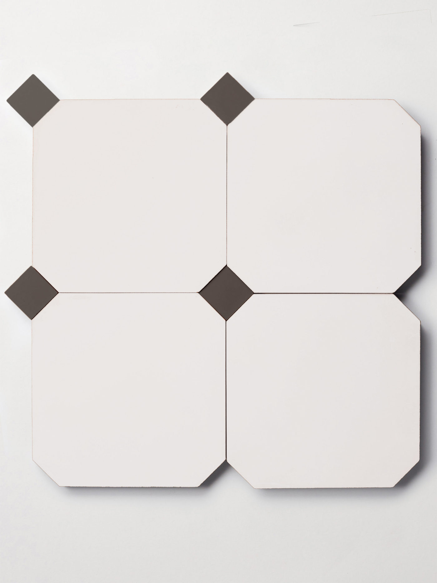 a set of black and white tiles on a white surface.