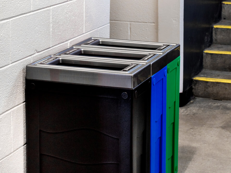 triple station for waste recycling and organics collection with color coded bodies in a hockey arena
