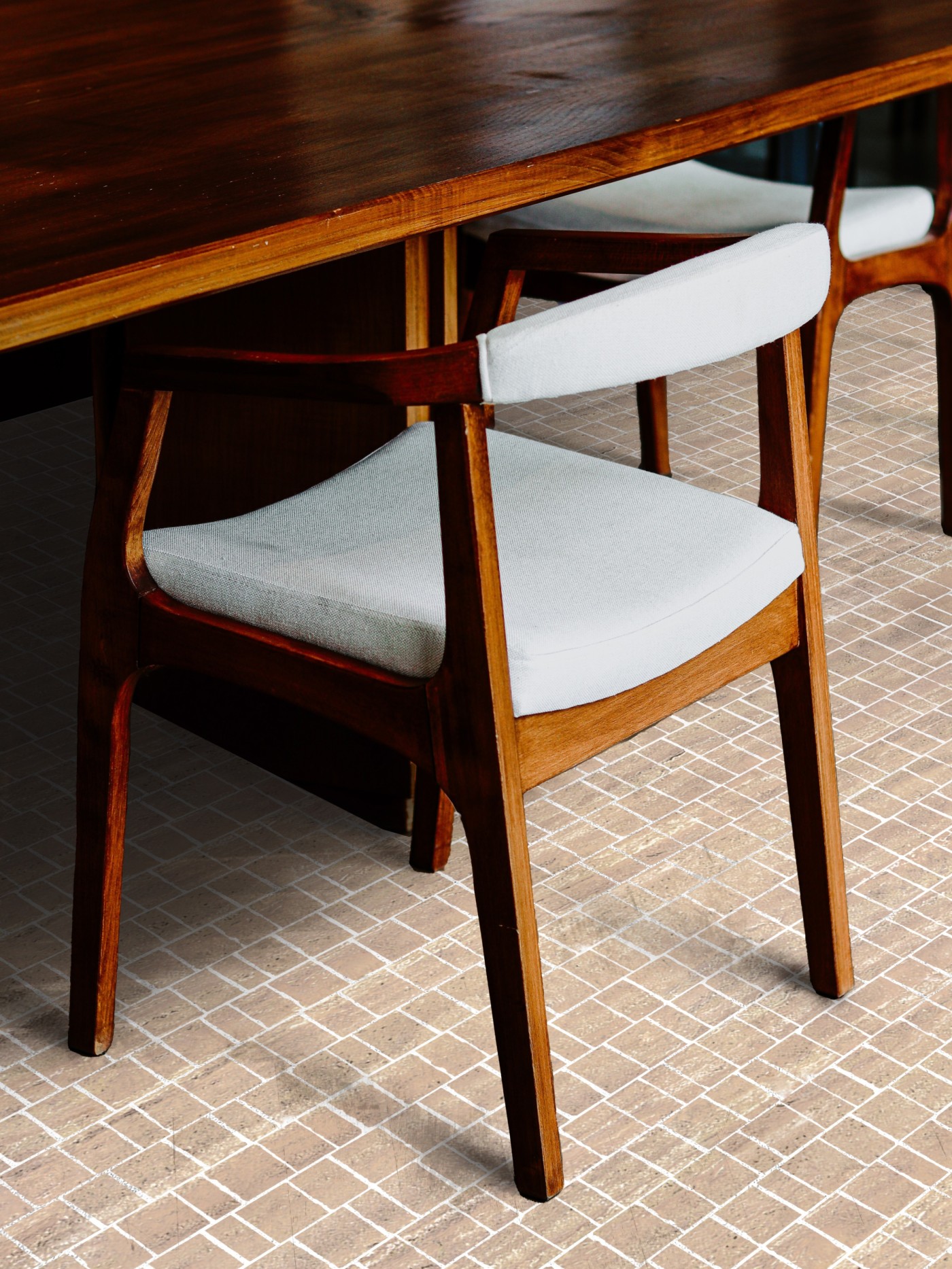 a wooden table and chairs in a dining room with tiled floor.