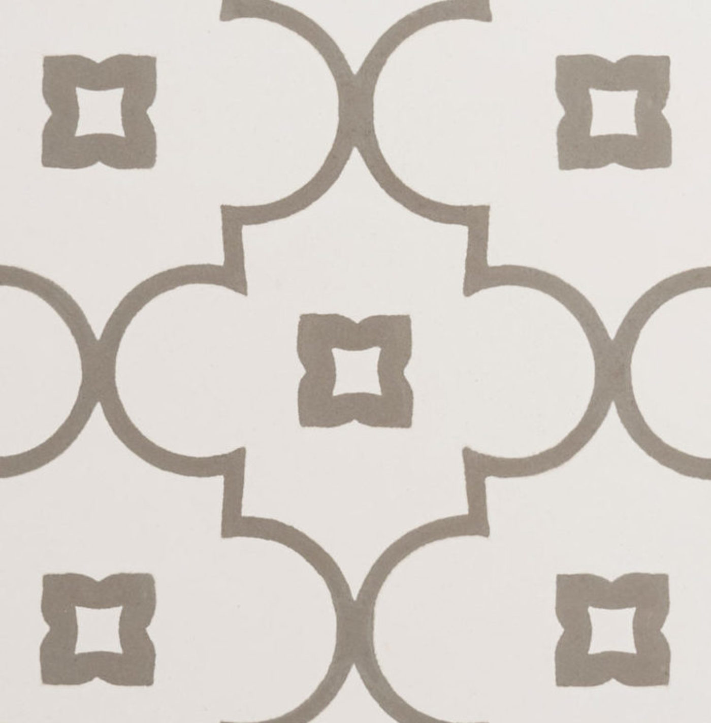 a white tile with grey and white designs.