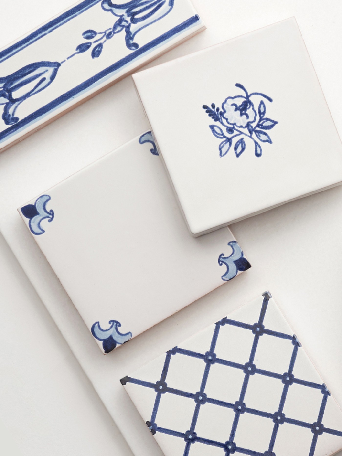 a set of blue and white tiles with designs on them.