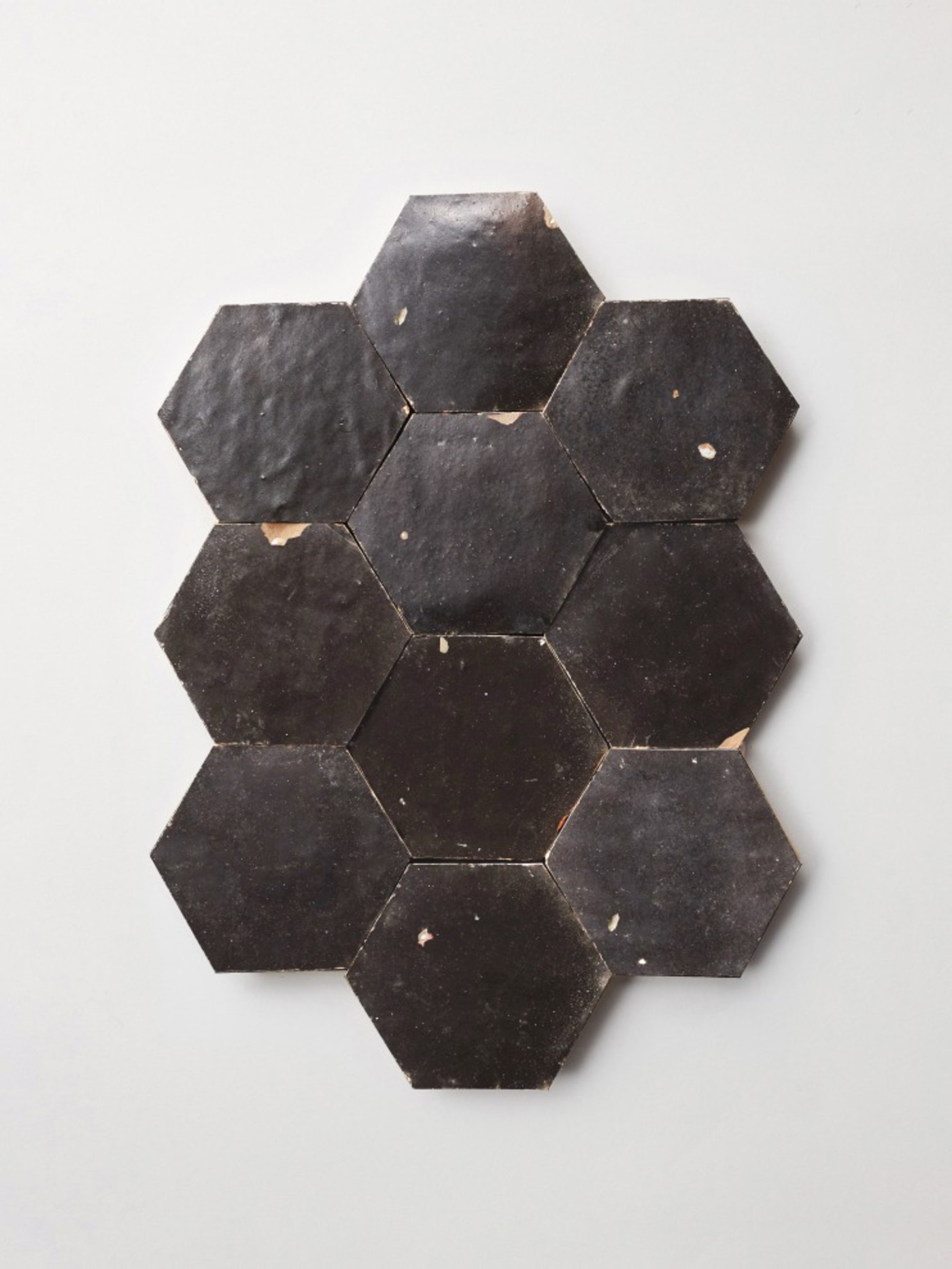 black hexagonal tiles on a white surface.