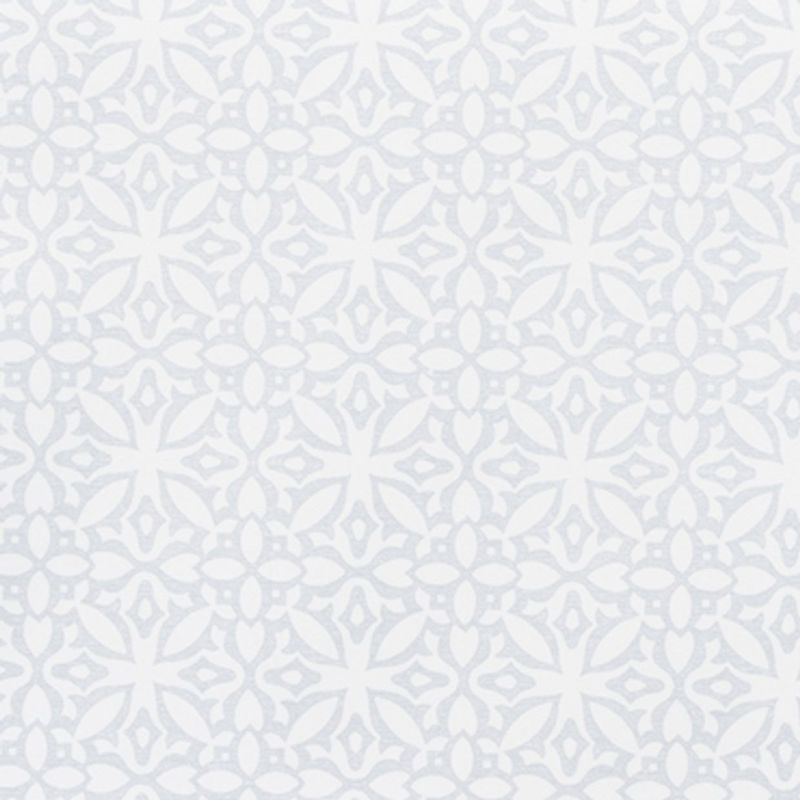Pale gray-blue stenciled wallpaper with a repeating floral-medallion motif covers the entire surface, creating a subtle textured pattern; interior wall, evenly lit with soft, diffused daylight.