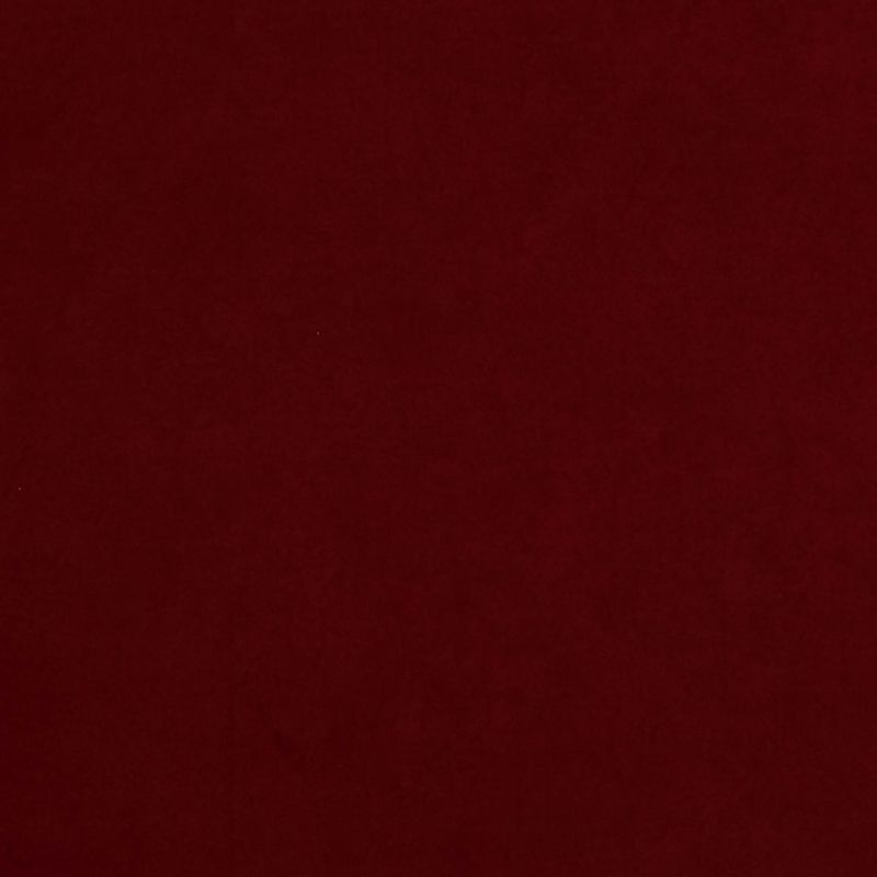 Solid burgundy fabric fills the frame, lying flat with subtle texture; evenly lit, featureless surface suggests a plain backdrop or sheet in low, diffuse light.