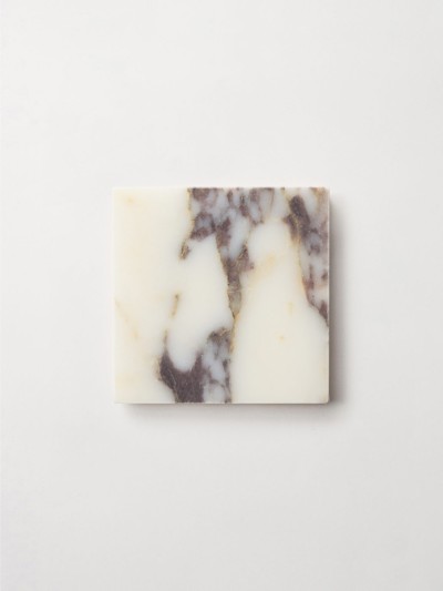 a white marble soap bar on a white surface.