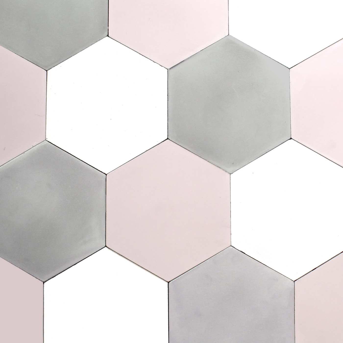 a surface covered with white, pink, and grey hexagonal tiles.