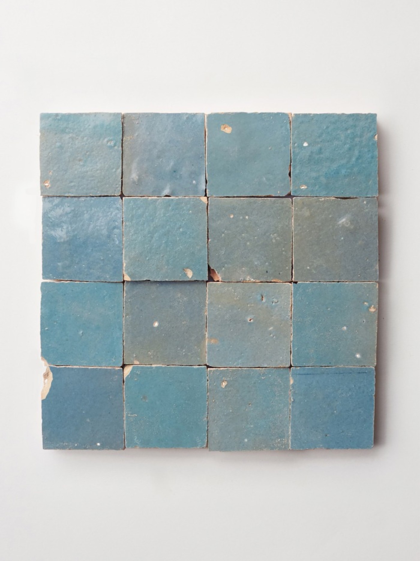 square blue tiles on a white surface.