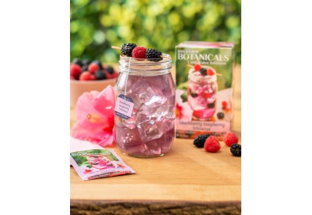 Glass of  Blackberry Raspberry Hibiscus Cold Water Infusion with tea box and foil