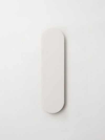 a white plate on a white wall.
