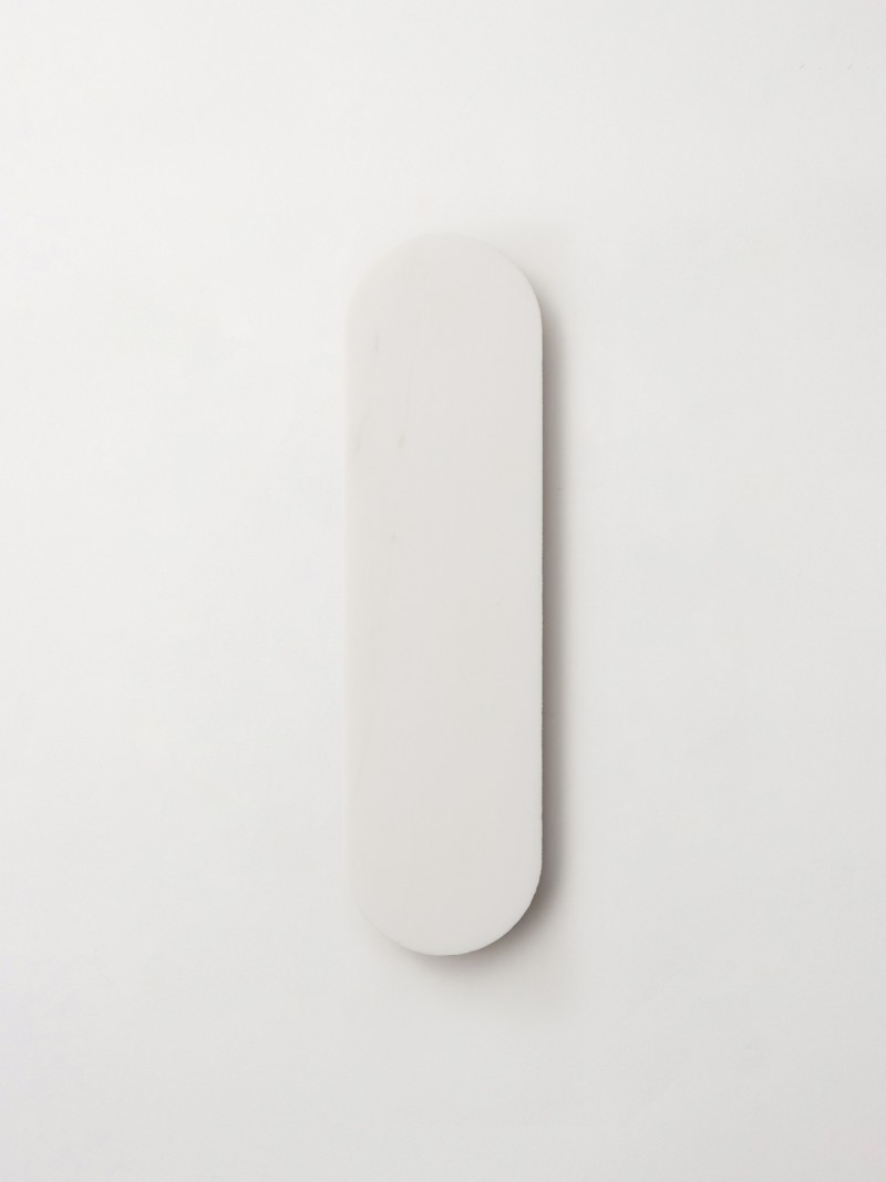a white plate on a white wall.
