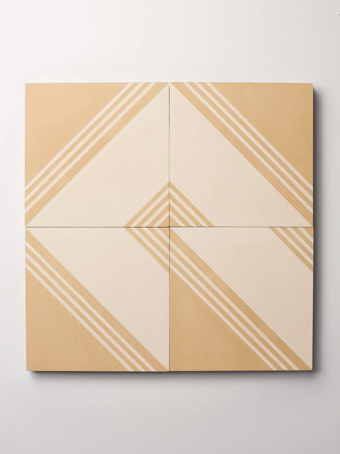 four tiles with a beige and white patterns on them.