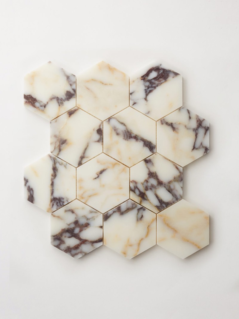 a white marble hexagon tile on a white surface.