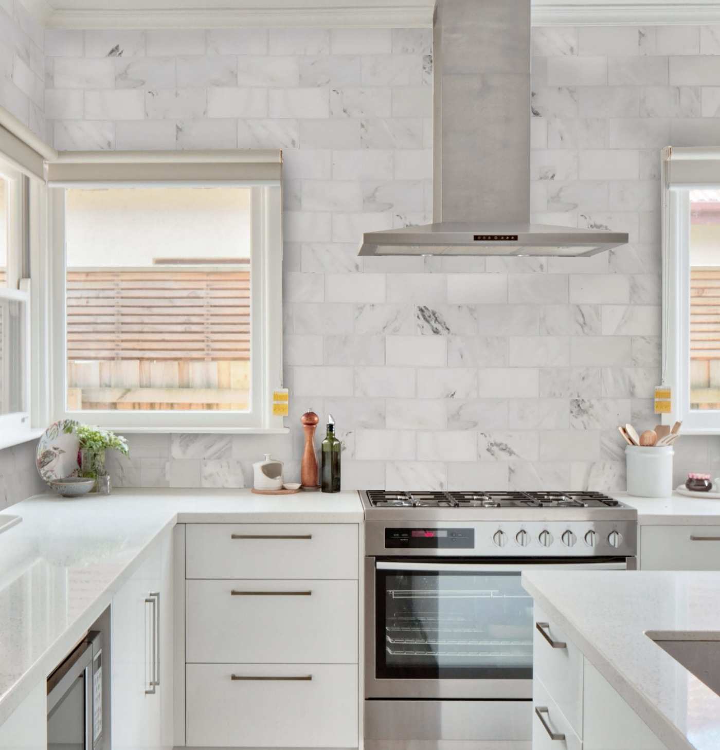 a white kitchen with a stove and oven.