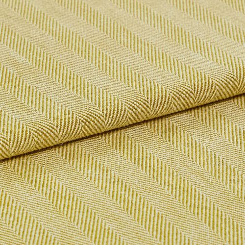 Yellow-green woven fabric with diagonal ribbed herringbone pattern; folded over itself, revealing layered texture; close-up studio-lit view emphasizing the weave and pattern across a flat surface.