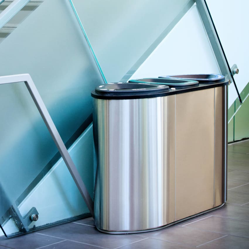 stainless steel waste and recycling container in a modern office building