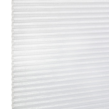 White pleated cellular window blind with visible left edge and horizontal folds, closed and diffusing daylight; close-up view against a bright, neutral background.