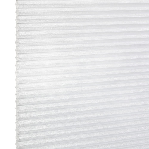 White pleated cellular window blind with visible left edge and horizontal folds, closed and diffusing daylight; close-up view against a bright, neutral background.