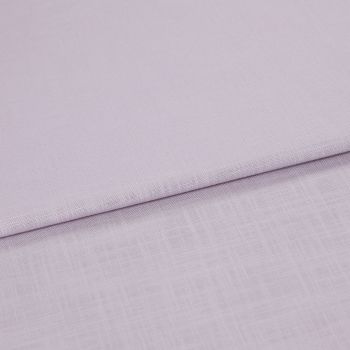 Pale lavender linen fabric folded across the frame, edge running diagonally; resting in soft layers, close-up on fine woven texture under diffuse lighting.