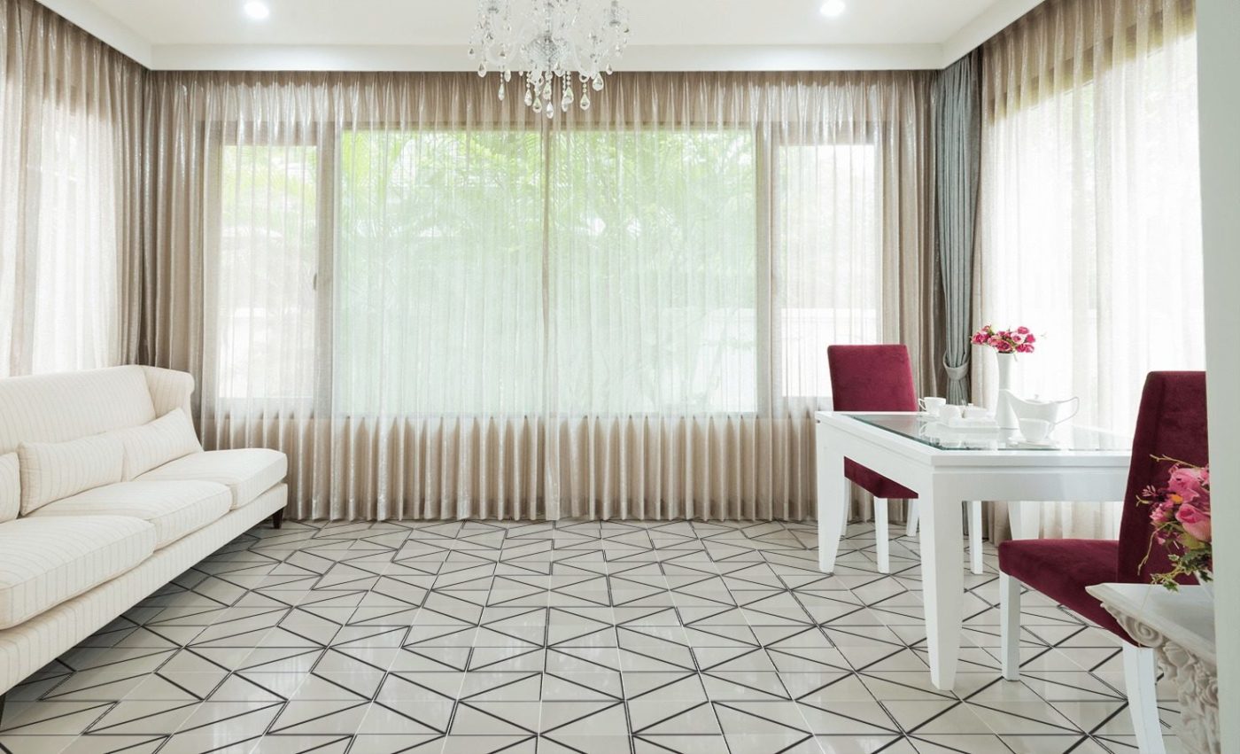 a living room with a white couch and a white table.