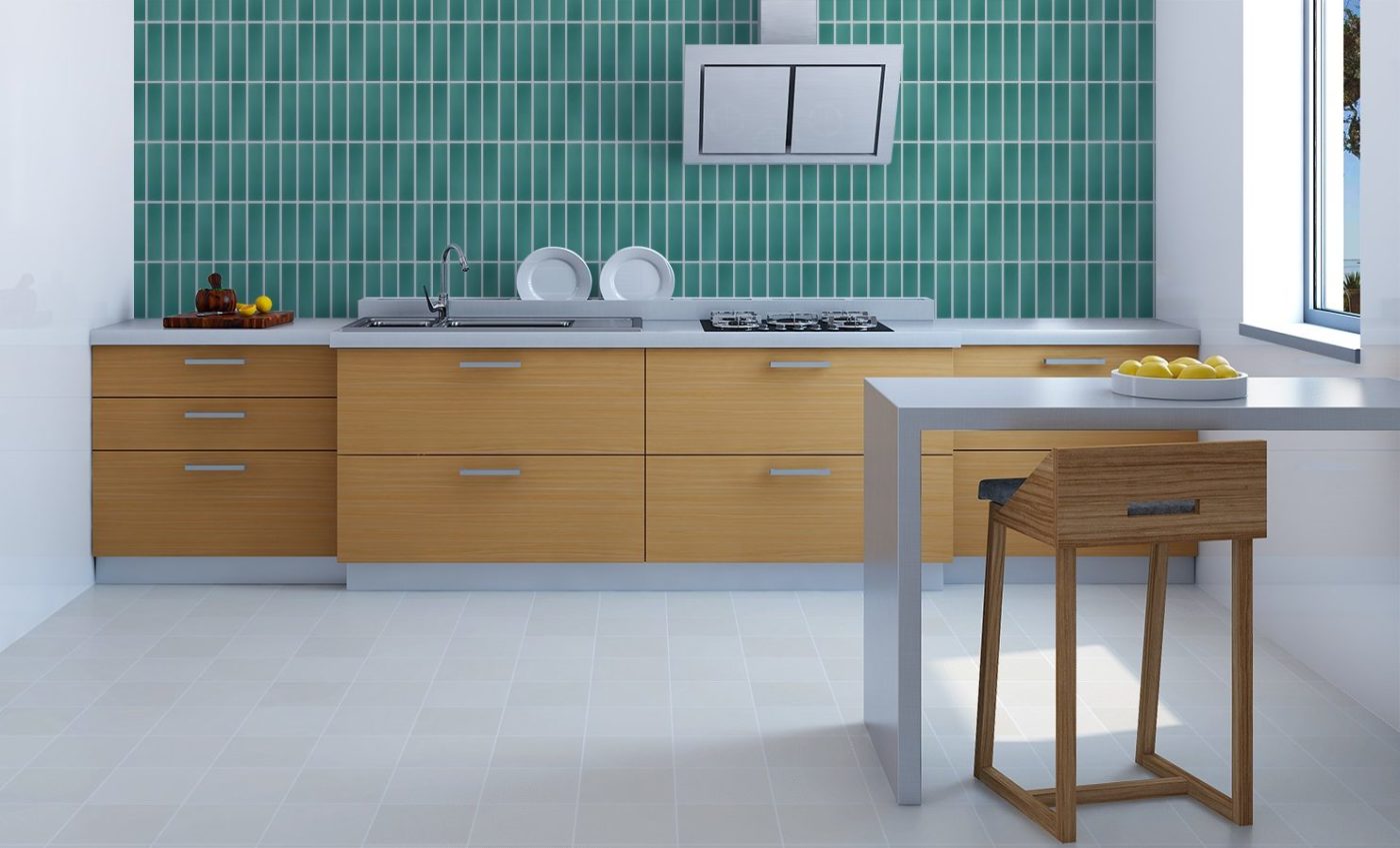 a kitchen with a turquoise-green tiled wall.