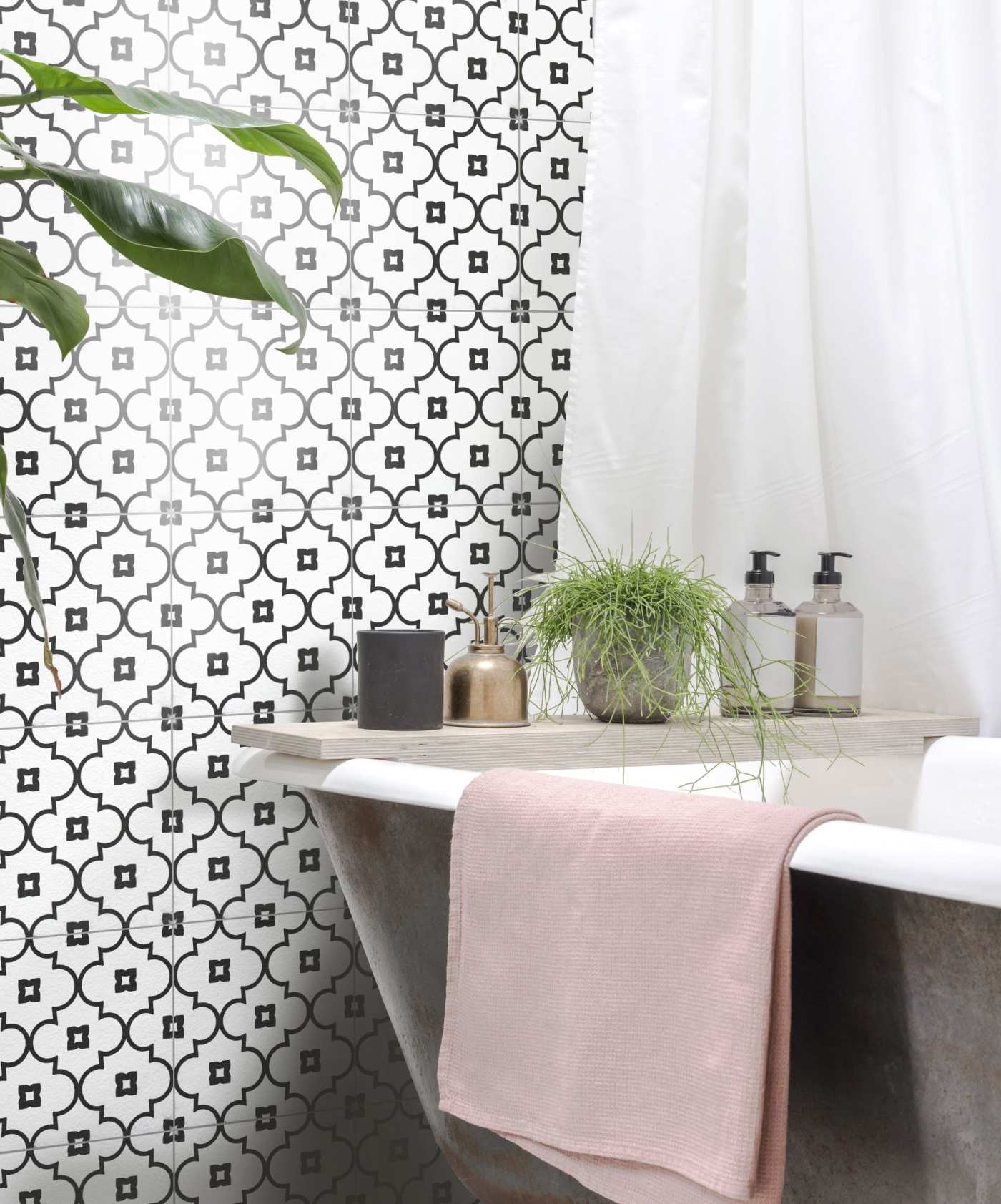 a bathroom with a black and white tiled wall.