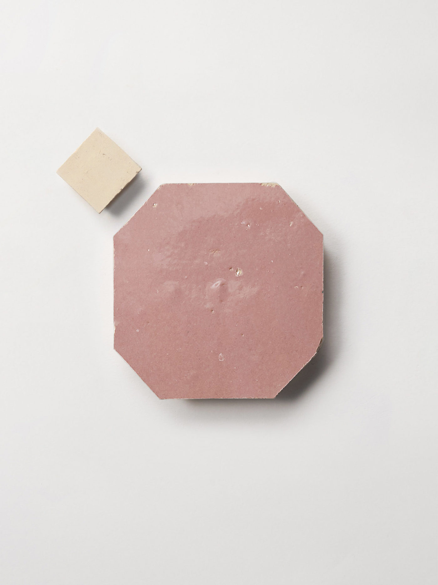 pink and beige tiles on a white surface.