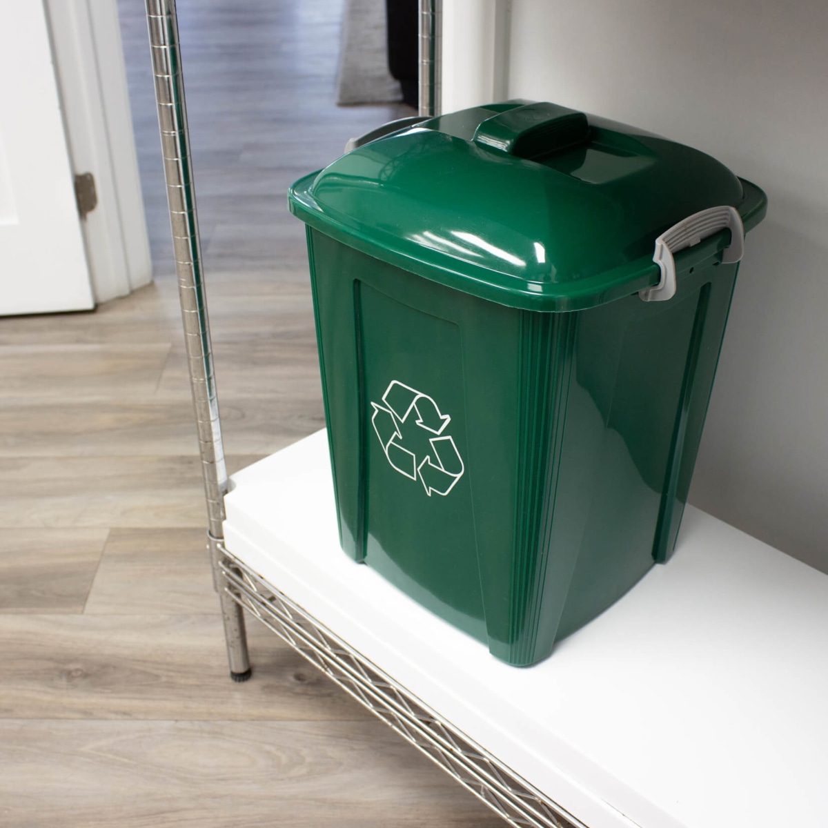 durable plastic recycling bin made from green HDPE sitting on a lunch room shelf