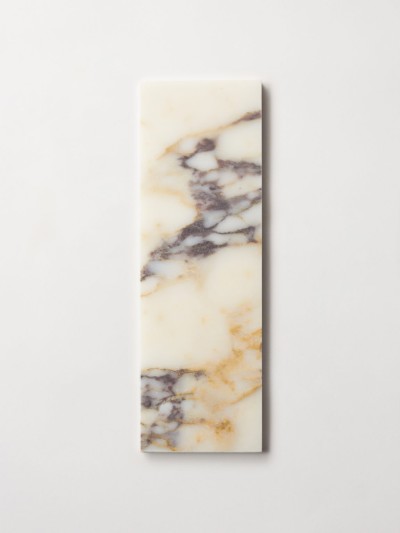 a rectangular piece of marble on a white surface.