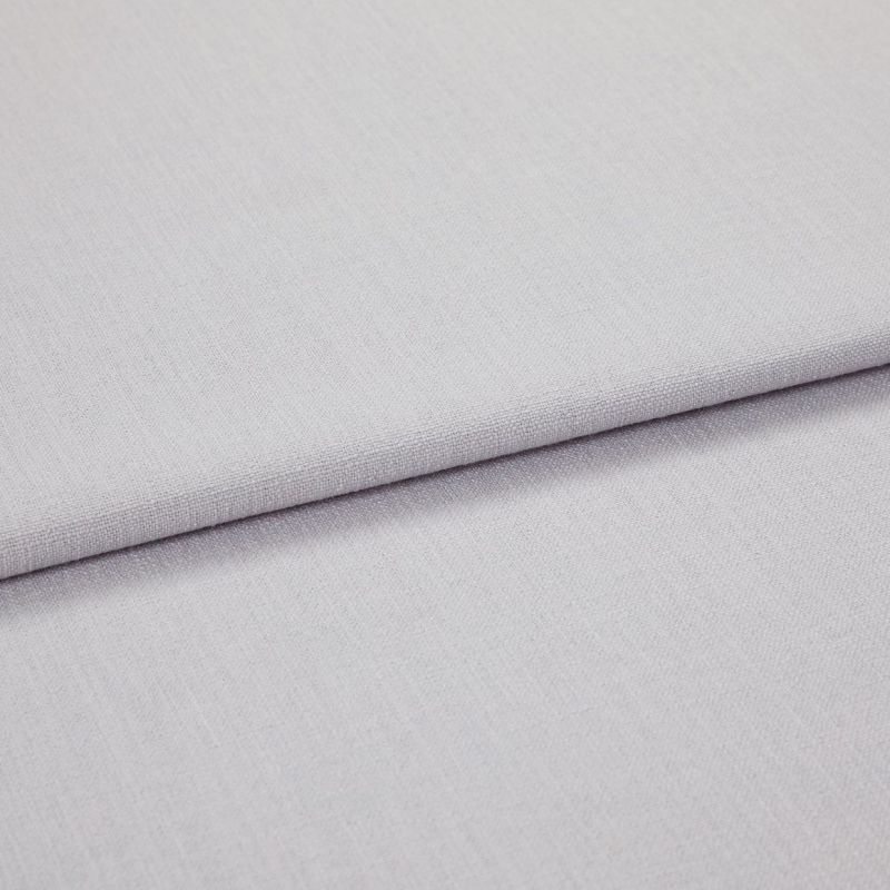 Light grey woven fabric panels overlapping in a folded horizontal seam, showing fine texture and tight weave; close-up, soft even lighting on a neutral surface.