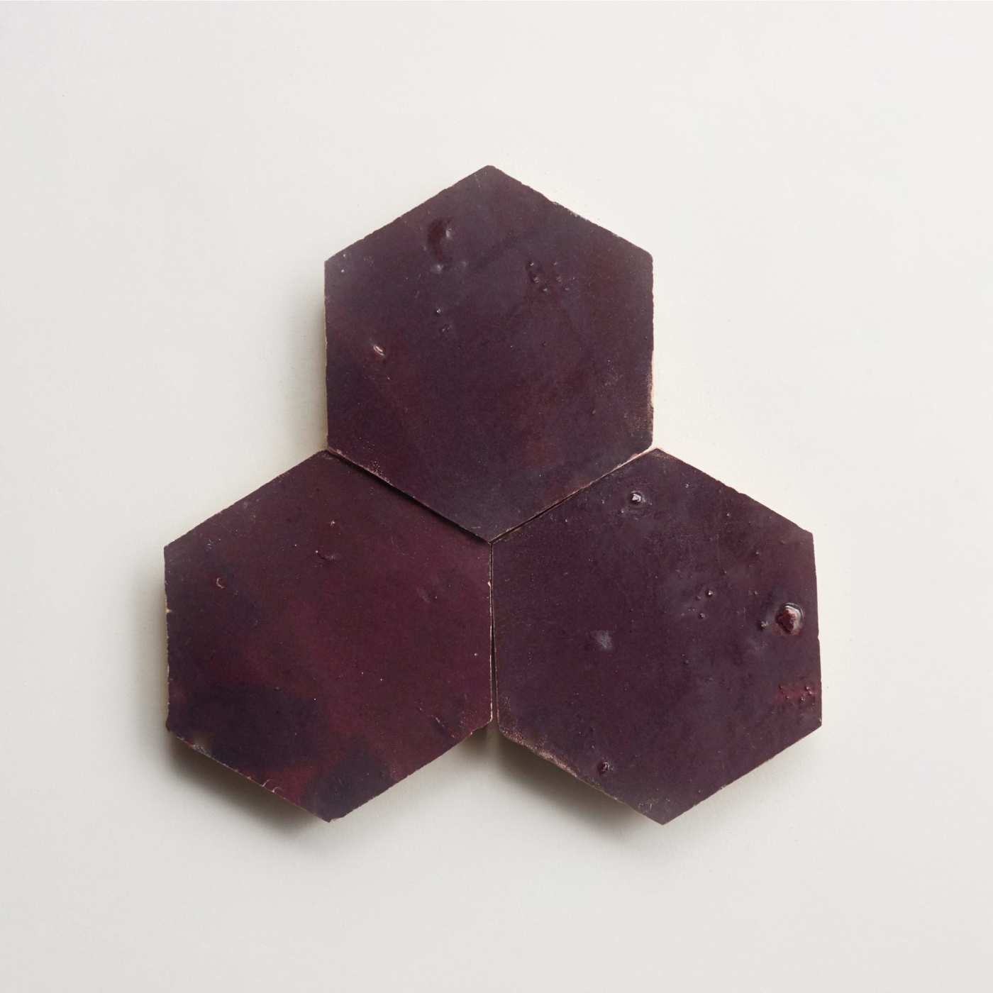 three purple hexagon tiles on a white surface.