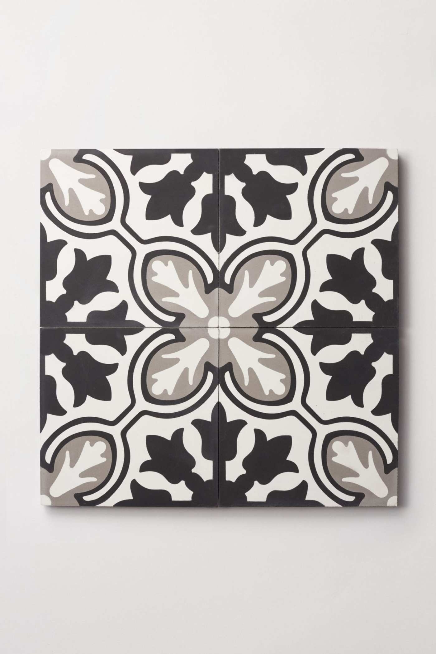 a black and white tile design on a white surface.