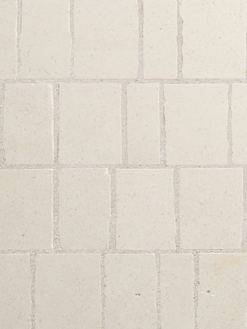 a close up image of a white tiled wall.