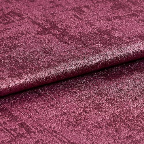 Crushed velvet fabric swatch, folded across the frame with a subtle roll, shimmering and reflecting light; deep magenta color, close-up studio shot emphasizing soft, textured pile.