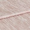 Shimmering, ribbed blush-pink fabric folded once, displaying horizontal crinkled texture and metallic sheen; close-up studio view with soft, even lighting emphasizing the tactile surface.