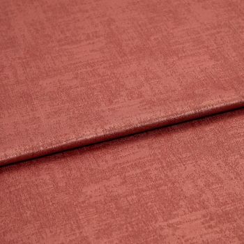 Folded rose‑colored textured fabric, a soft velvet-like material with a horizontal overlap fold; lit evenly in a close-up studio view showing subtle sheen and woven surface detail.