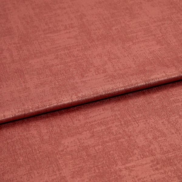 Folded rose‑colored textured fabric, a soft velvet-like material with a horizontal overlap fold; lit evenly in a close-up studio view showing subtle sheen and woven surface detail.
