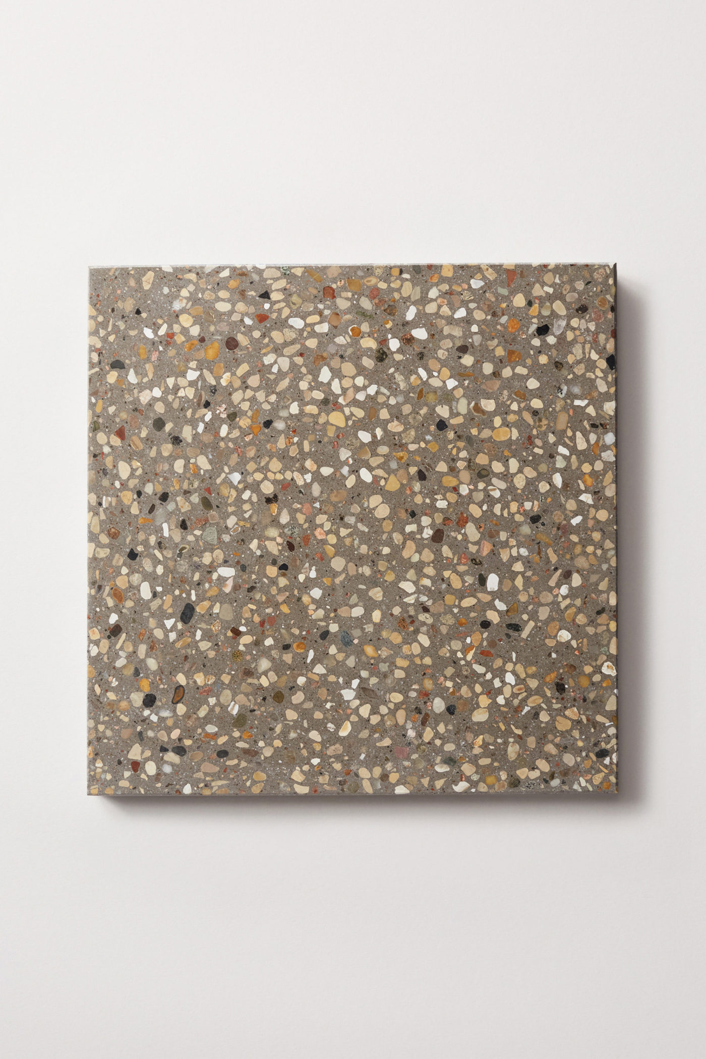 a grey terrazzo tile on a white surface.