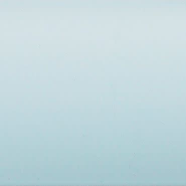 Pale blue painted wall occupying the frame, showing faint texture and a subtle vertical gradient, evenly lit and softly reflecting light in a minimal, featureless interior.