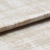 Beige-and-white distressed-pattern fabric panel with a horizontal fold, resembling a Roman blind; photographed close-up on a neutral surface under soft, even lighting.