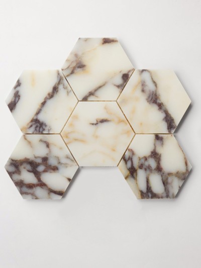 a set of marble hexagon tiles on a white surface.