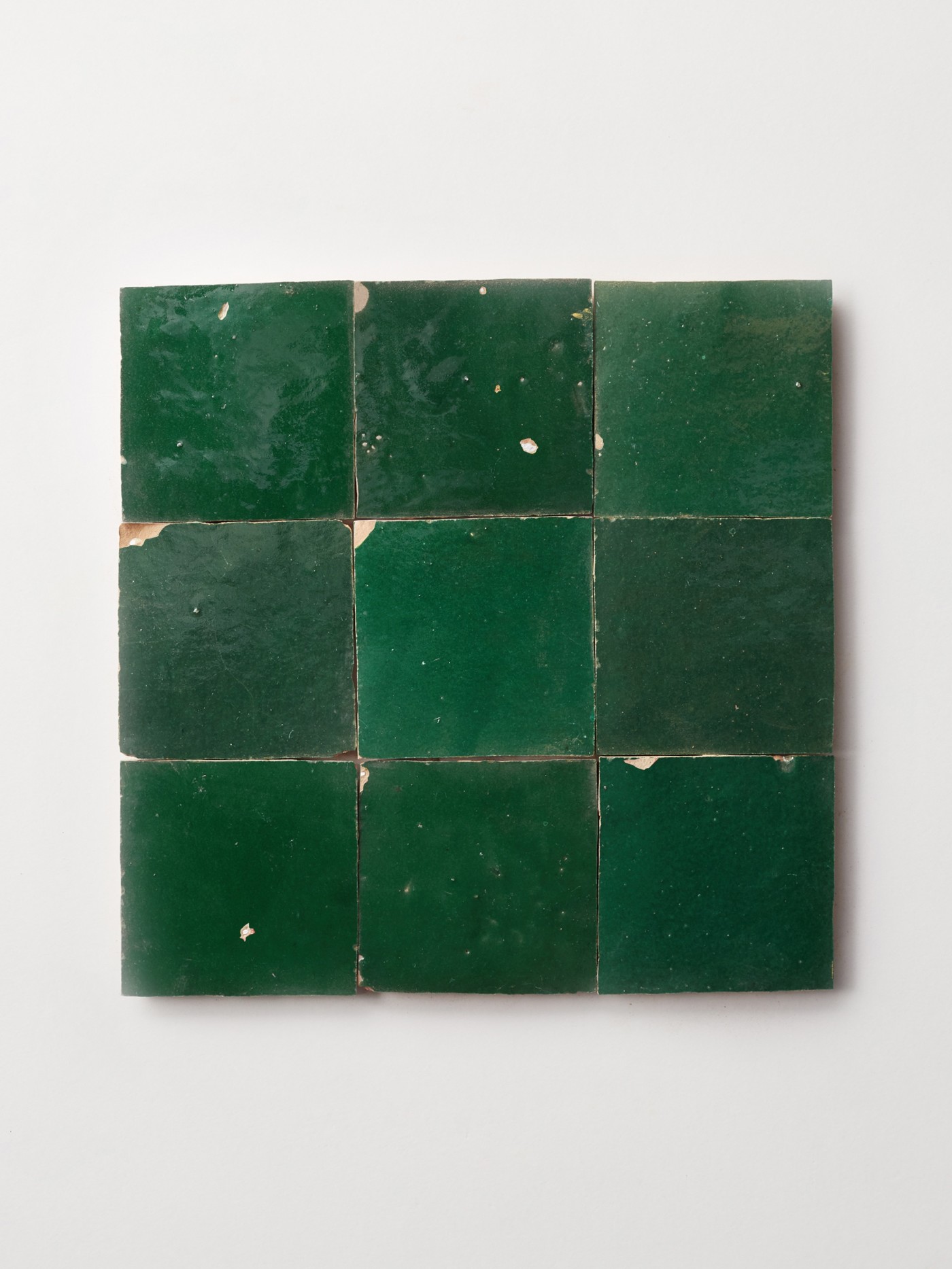 green tiles on a white surface.