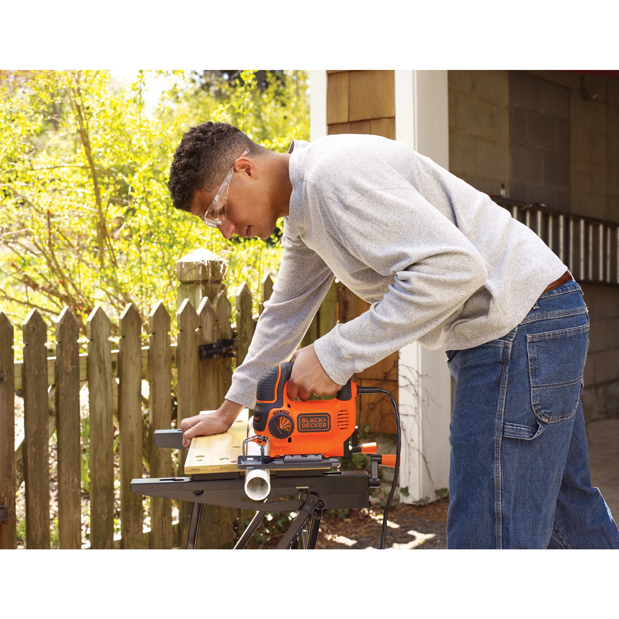 Black and decker jig saw smart select being used by a person.