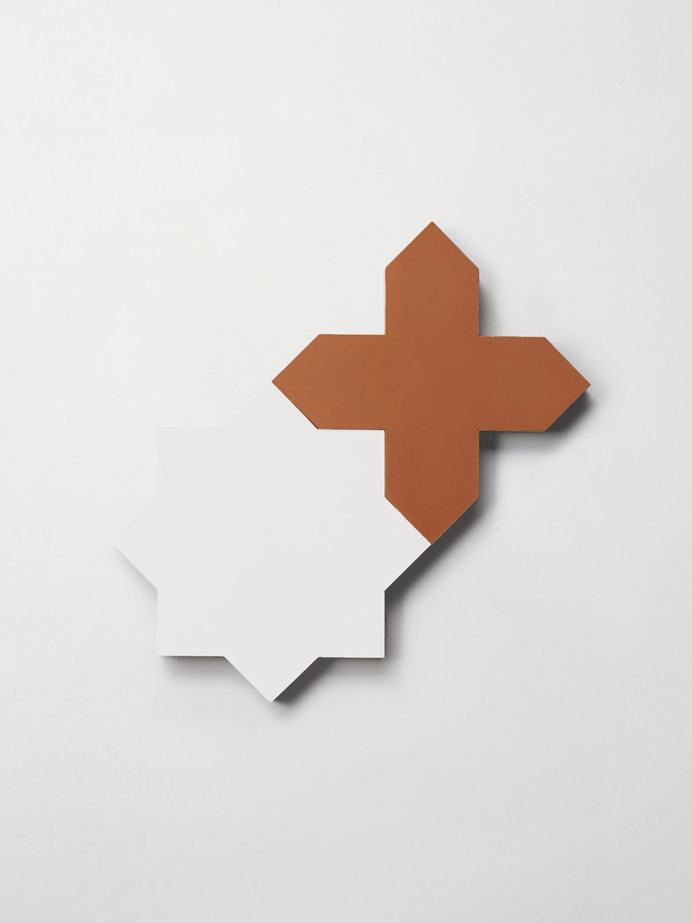 a white star and red cross tile on a white surface.