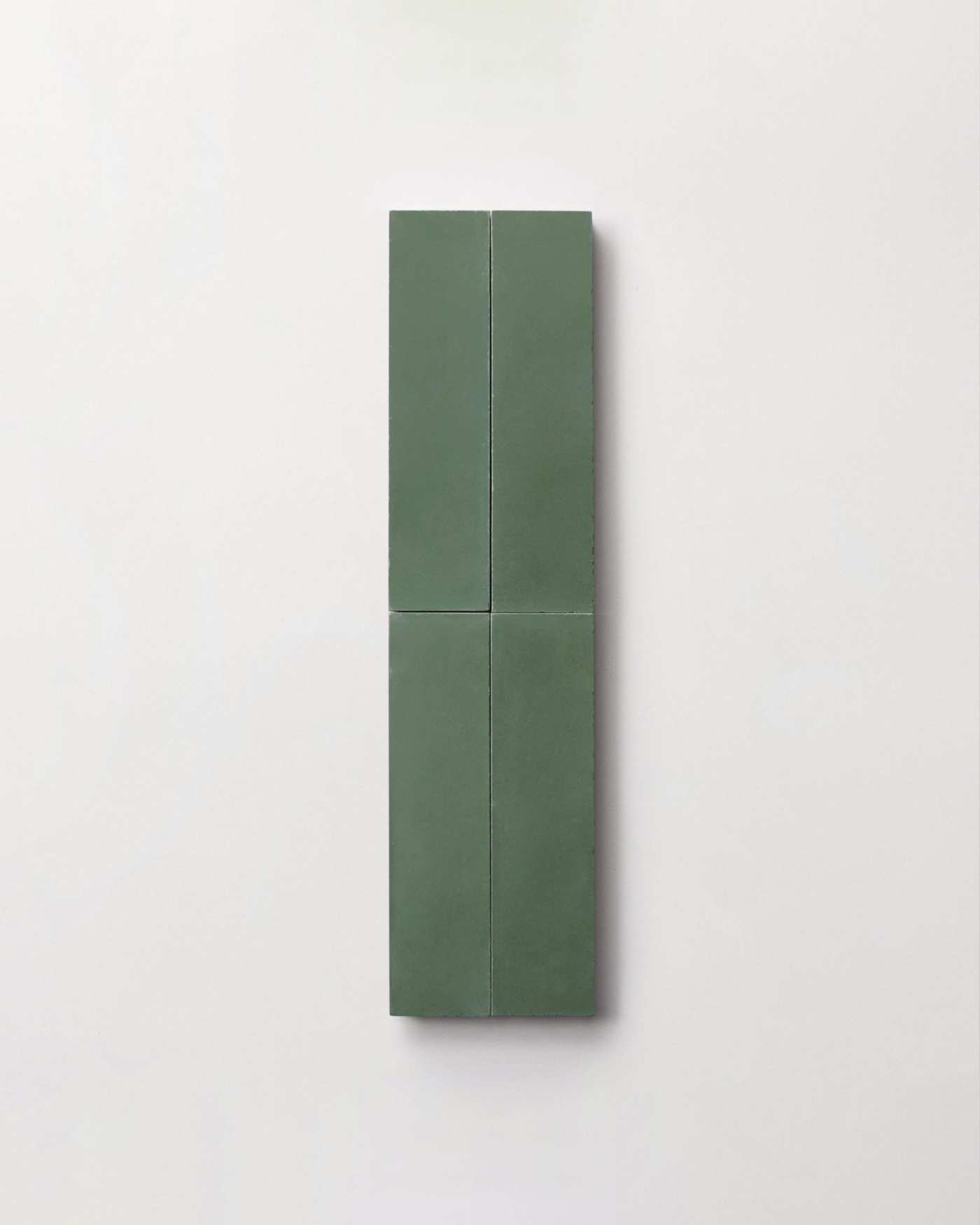 four green rectangle tiles on a white surface.