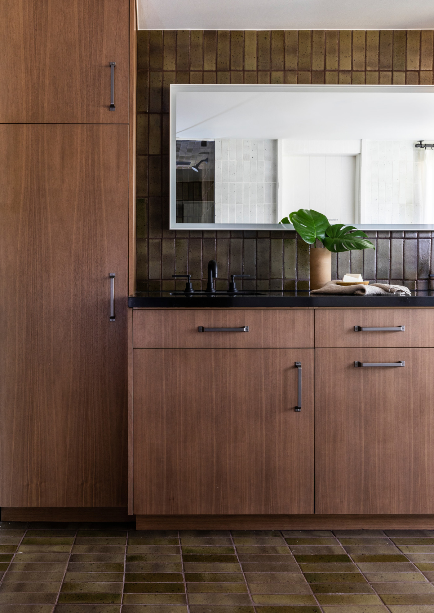 a kitchen with brown cabinets and a mirror.